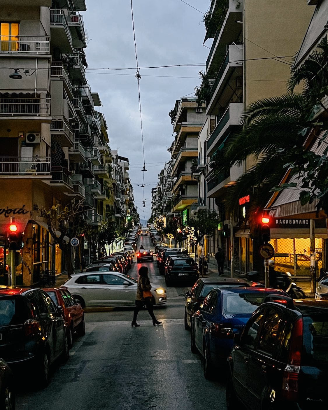 A pedestrian street in central Athens at dusk with people out walking