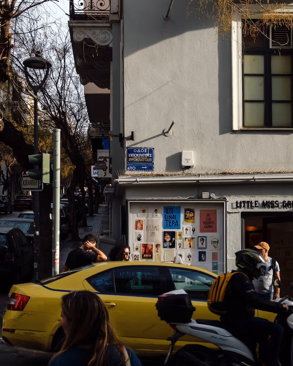 A yellow Athens taxi on the street
